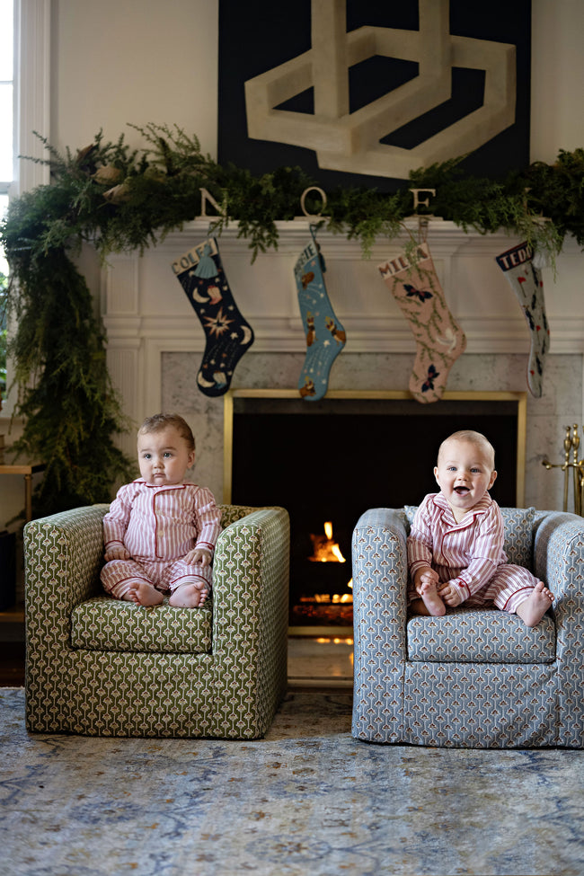 Two baby boys on patterned kids chairs