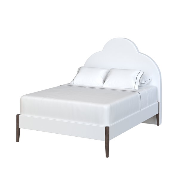 Coley Home scalloped upholstered bed with white bedding and wooden legs.