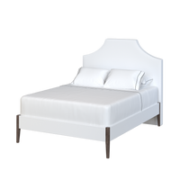 Coley Home crown bed with elegant white upholstery and stylish wooden legs.
