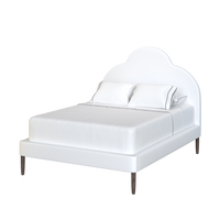 Coley Home customizable bed with scalloped headboard and plush white fabric.