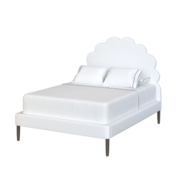 Coley Home scalloped bed with white linens and wooden legs.